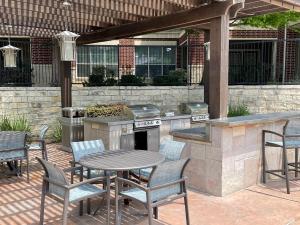 Apartments in NW San Antonio, TX - BBQ Area with Seating and Pergola